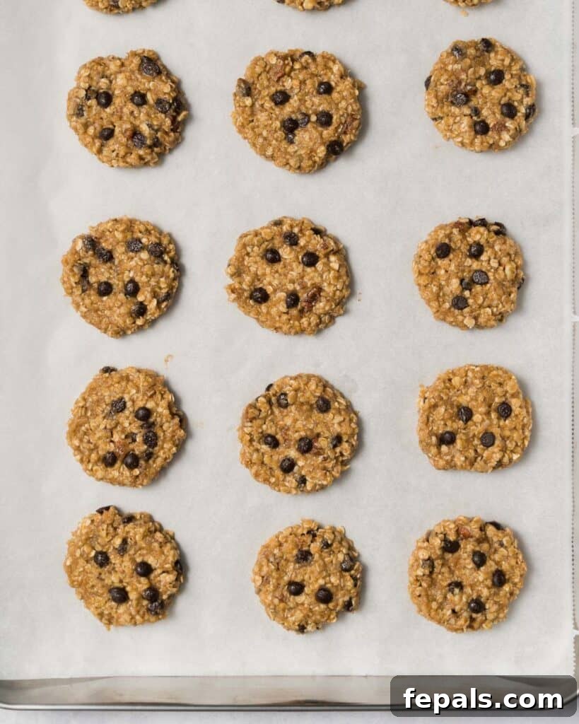 Wholesome Western Wonders 15 Cookie dough for Healthy Cowboy Cookies on a parchment lined baking sheet, ready for the oven.
