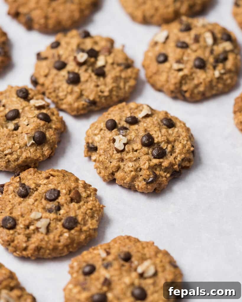 Wholesome Western Wonders 18 Side shot of baked Healthy Cowboy Cookies on parchment paper, showcasing their thick texture.