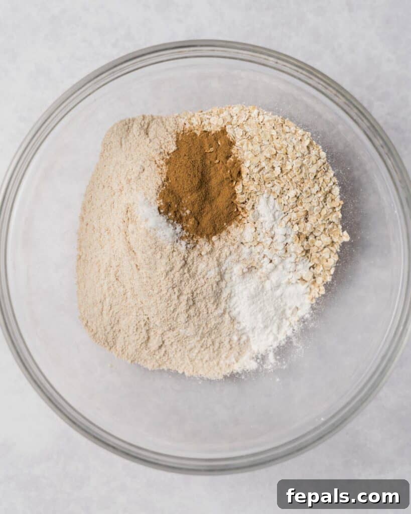 Wholesome Western Wonders 5 Cinnamon, oats and flour in a large bowl, ready for Healthy Cowboy Cookies.