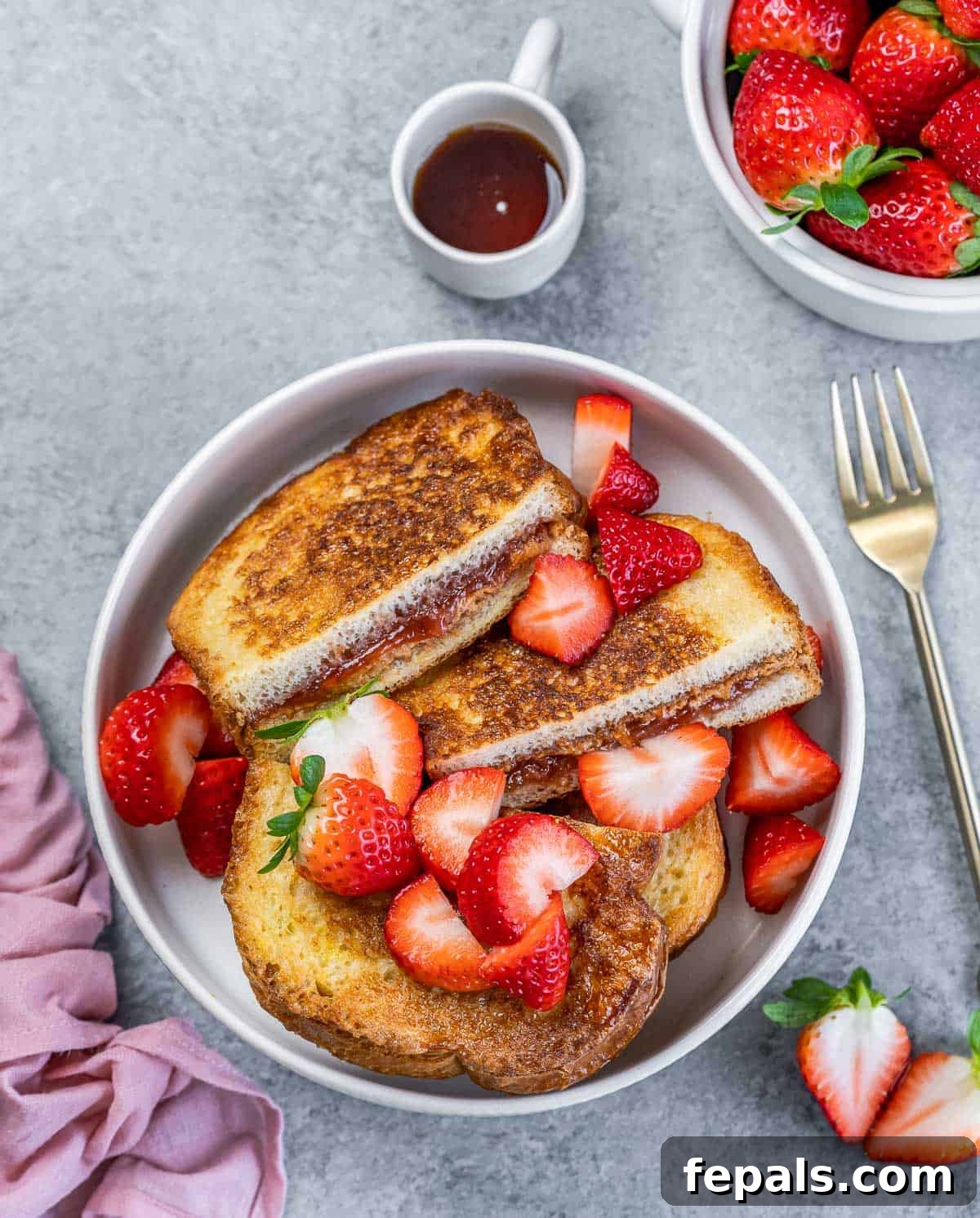 Peanut Butter Jelly French Toast Surprise 2 Top view of sliced stuffed French toast with peanut butter and jelly in a round white bowl.