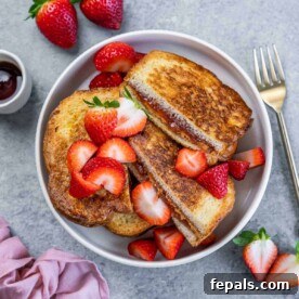 Peanut Butter Jelly French Toast Surprise 12 top view of sliced stuffed French toast with peanut butter and jelly in a round white bowl