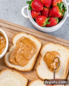 Peanut Butter Jelly French Toast Surprise 13 Spreading peanut butter on slices of bread.