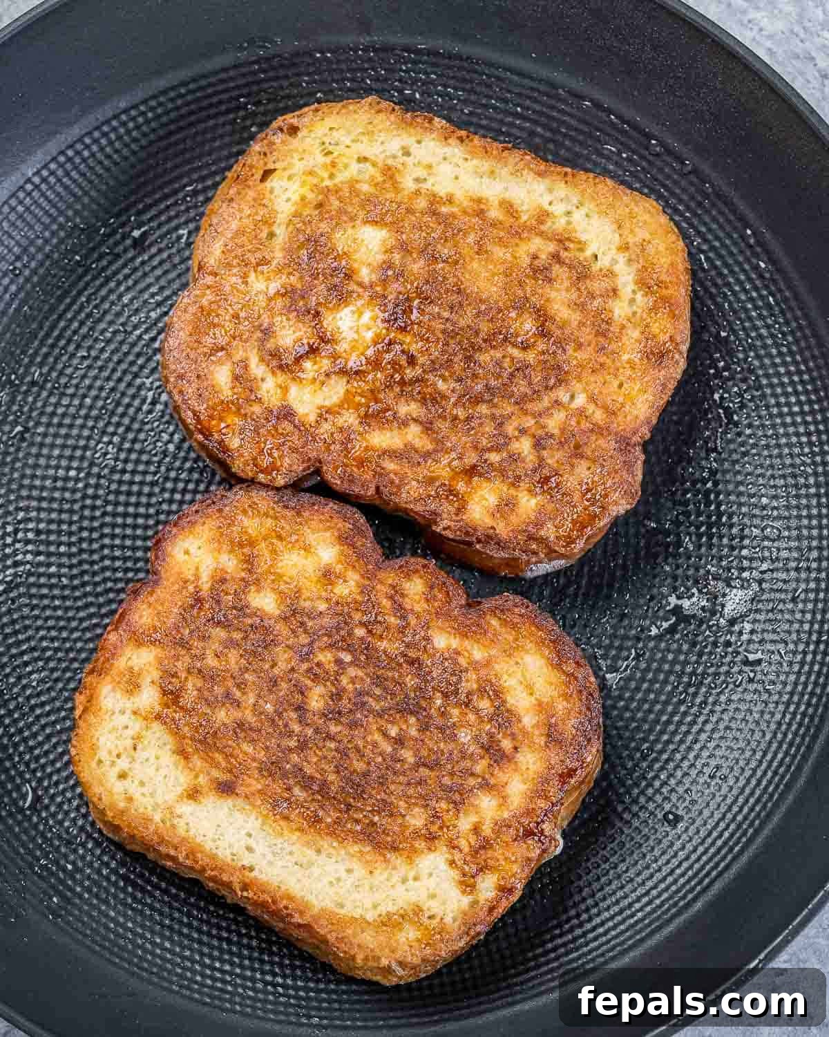 Peanut Butter Jelly French Toast Surprise 7 Cooking French toast in a pan.