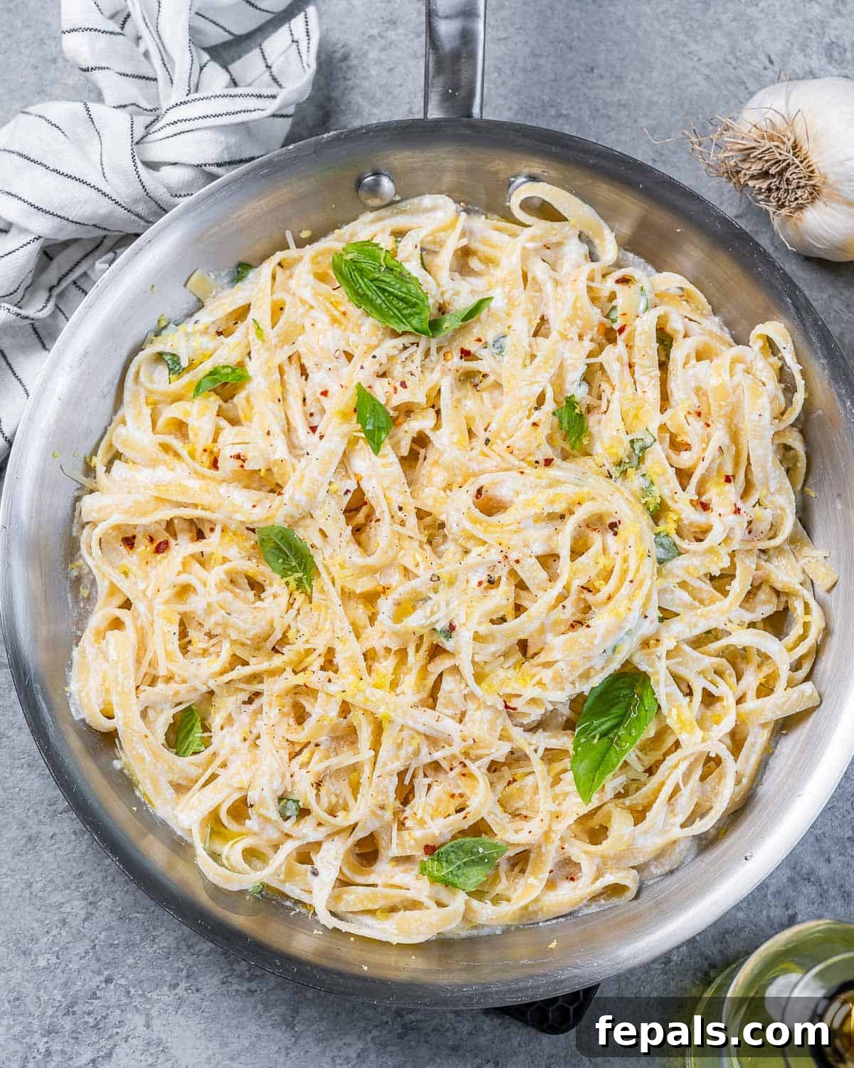 Bright Lemon Ricotta Pasta 2 Top view pan with lemon and ricotta creamy pasta with basil garnishes.