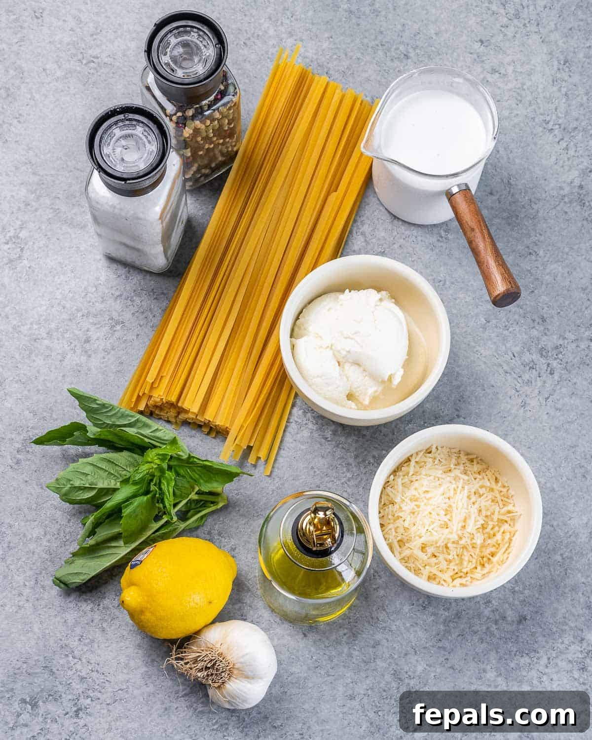 Bright Lemon Ricotta Pasta 4 Uncooked spaghetti, lemon, basil, olive oil, and bowls with milk, ricotta and parmesan cheese.