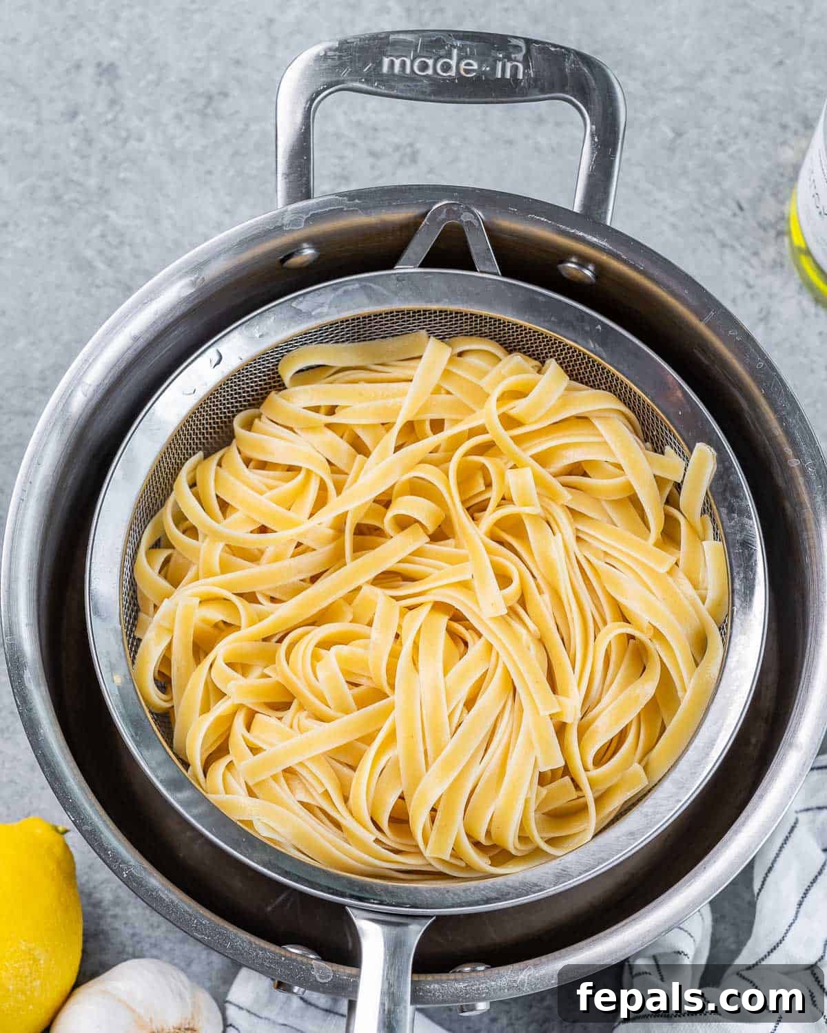 Bright Lemon Ricotta Pasta 5 Draining pasta in a colander.