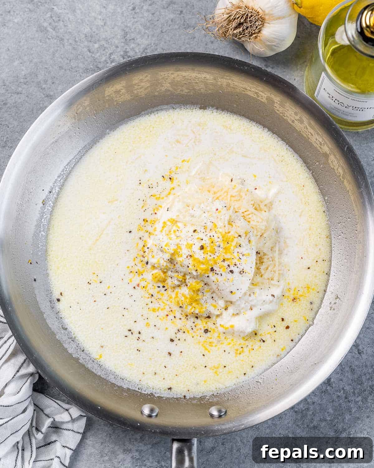 Bright Lemon Ricotta Pasta 6 Adding milk, lemon zest, lemon juice and ricotta to a pan.