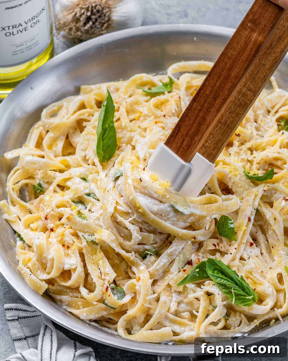 Bright Lemon Ricotta Pasta 8 Using tongs to stir Lemon Ricotta Pasta.