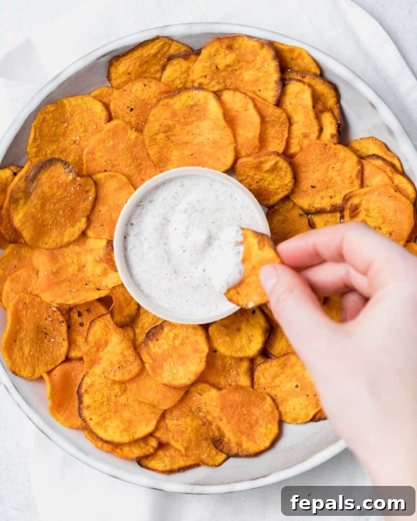 Crispy Air-Fried Sweet Potato Crisps 2 top view of a bowl with sweet potato chips and a ranch dipping sauce in the middle