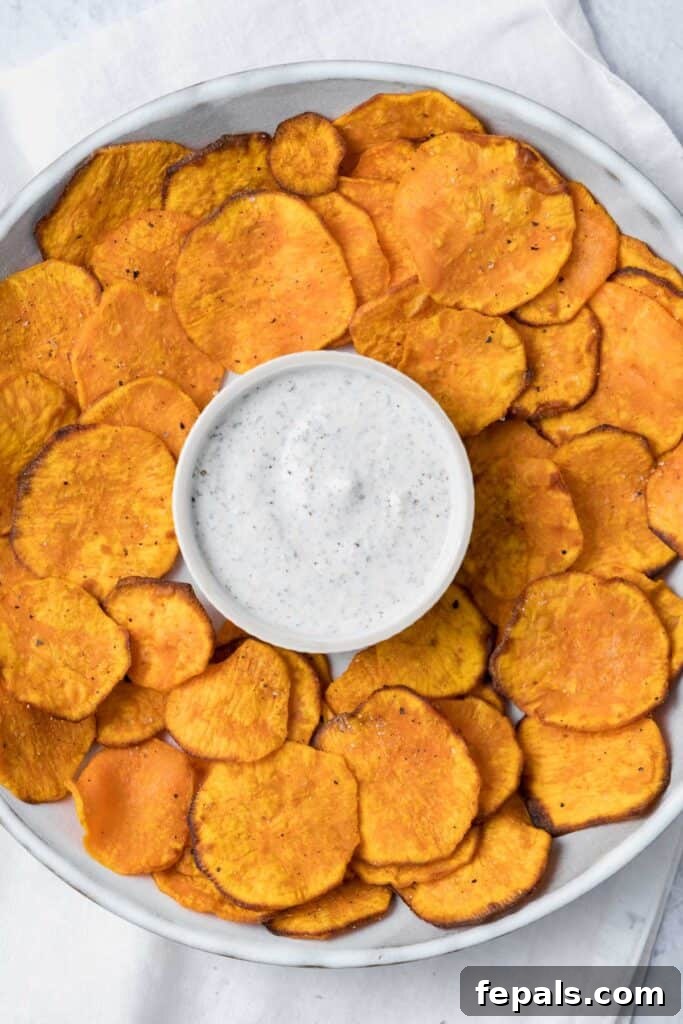 Crispy Air-Fried Sweet Potato Crisps 12 top view of sweet potato chips on a plate with ranch dip in the middle