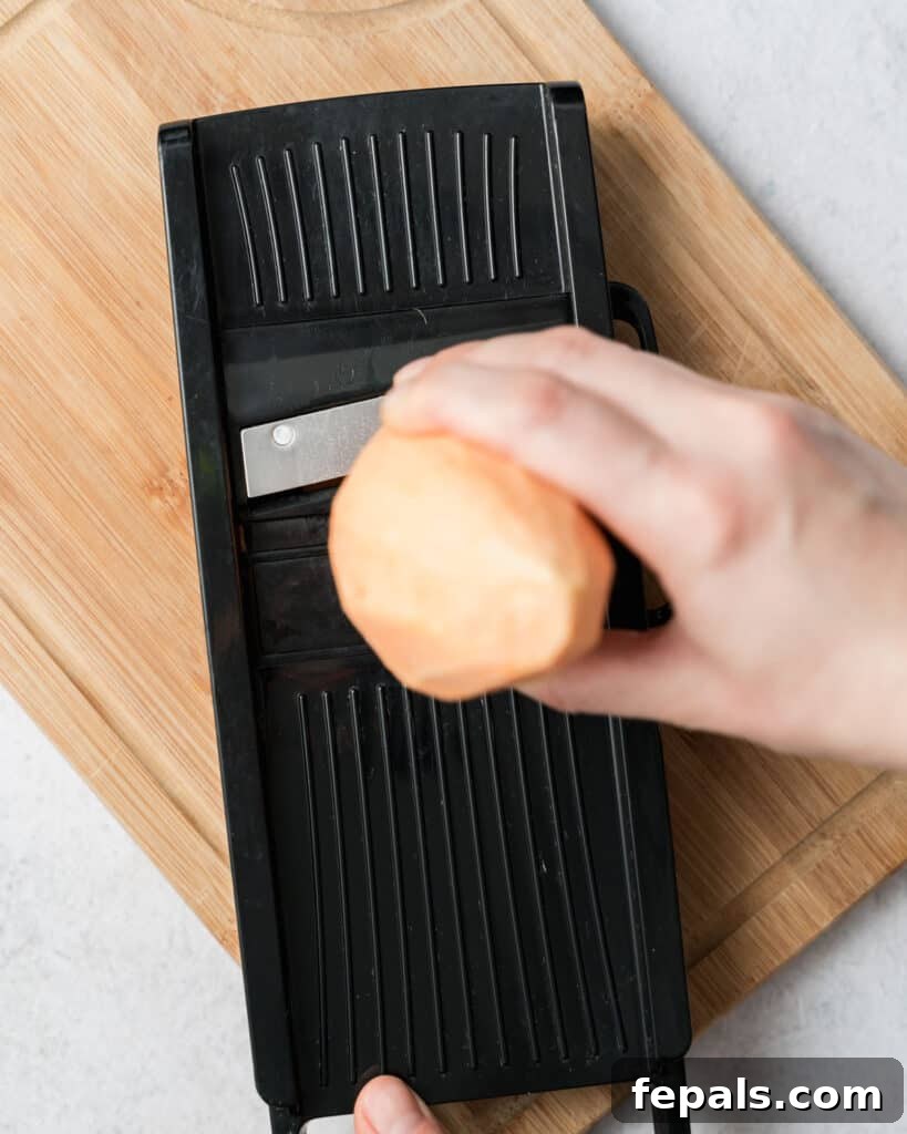 Crispy Air-Fried Sweet Potato Crisps 5 sweet potato being sliced using a mandolin slicer