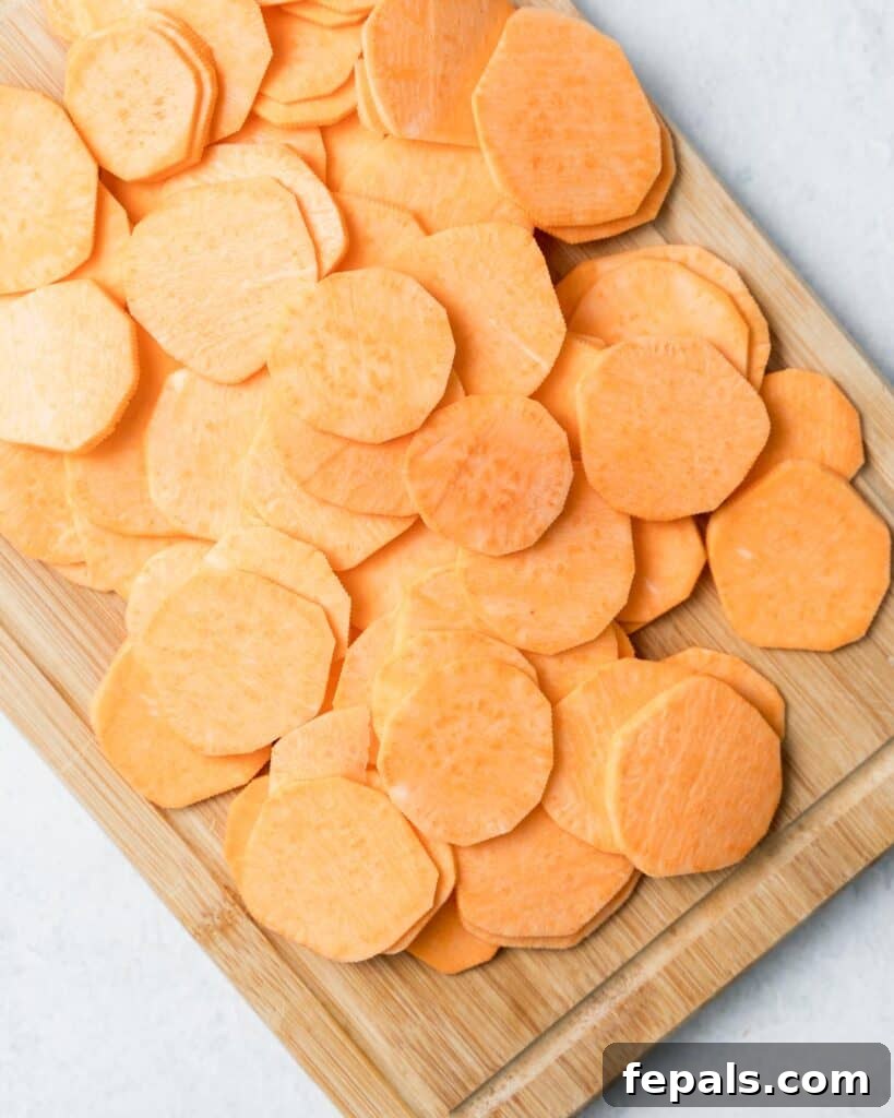 Crispy Air-Fried Sweet Potato Crisps 6 sweet potato slices on a cutting board