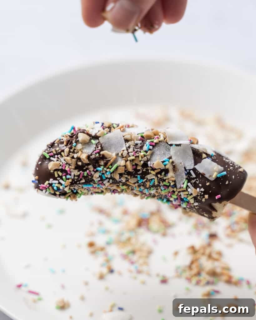 Frozen Chocolate Banana Bites 11 toppings being added over banana pops