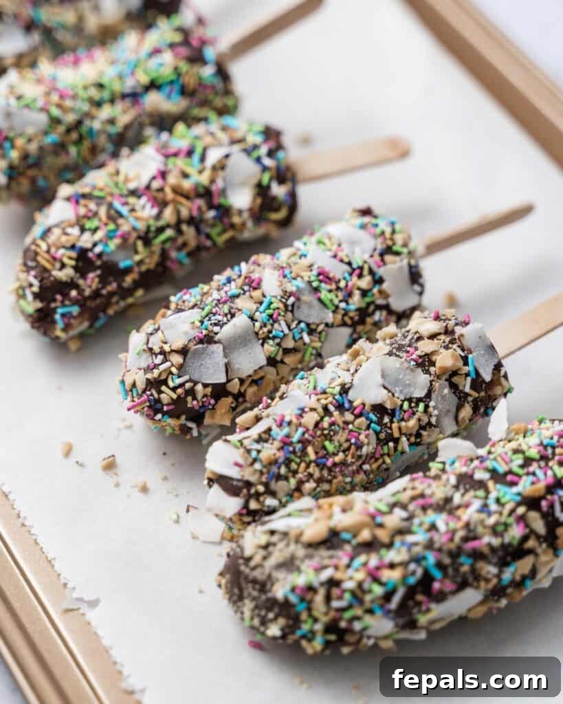 Frozen Chocolate Banana Bites 12 coated banana pops in sprinkles on a parchment