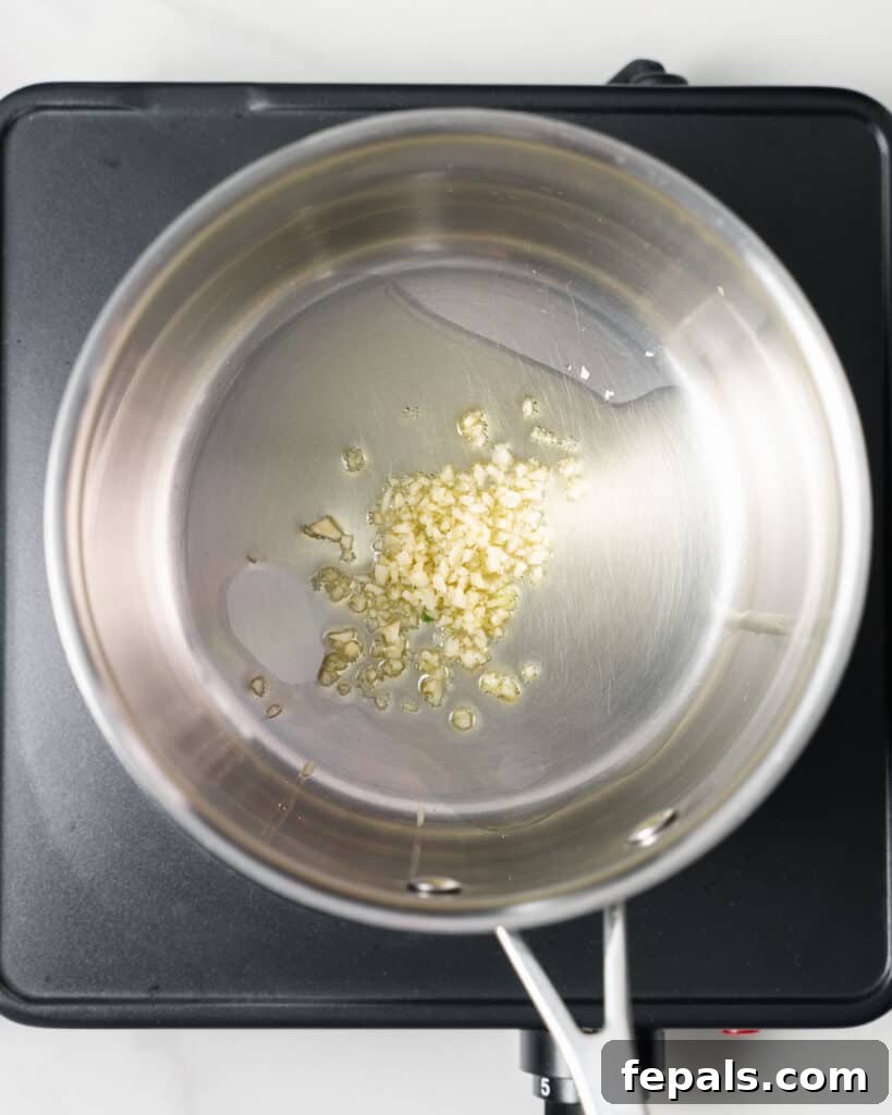 Garlic and olive oil in a pot.
