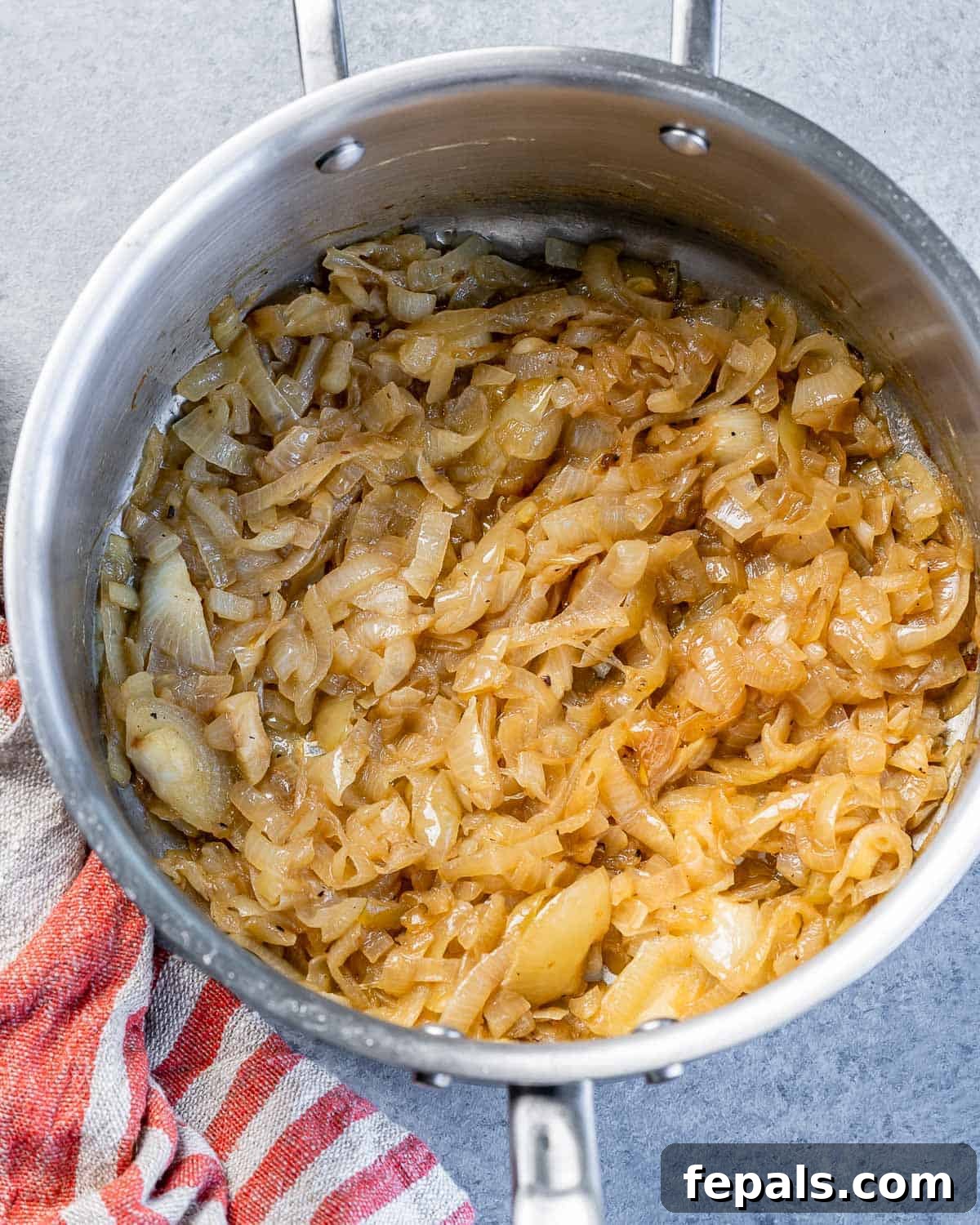 Effortless French Onion Elegance 6 Caramelizing onions in a pot.