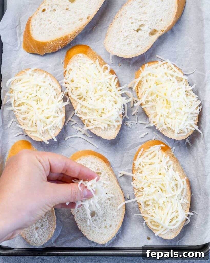 Effortless French Onion Elegance 7 Adding grated cheese to slices of bread.
