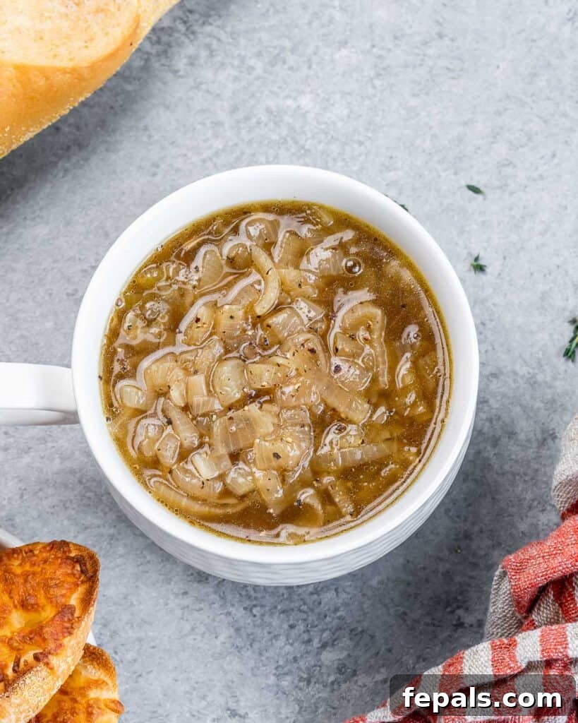 Effortless French Onion Elegance 8 French onion soup in a white bowl.