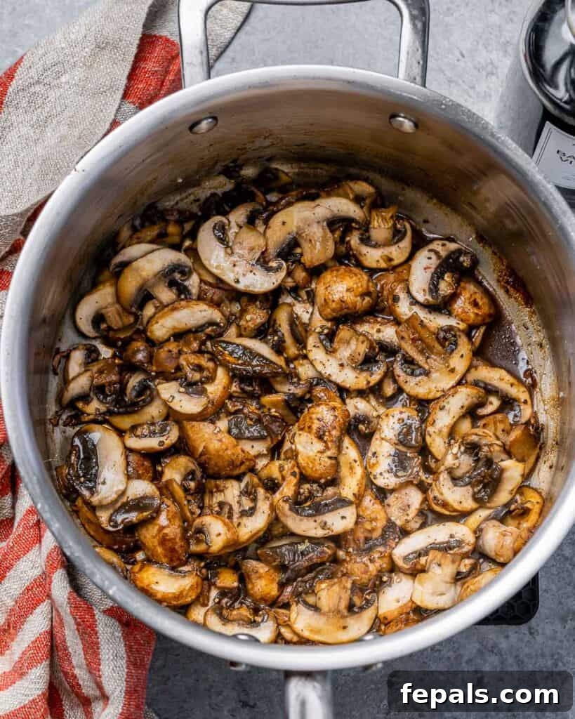 Hearty Beef Noodle Comfort 6 Mushrooms sautéing in a pot.