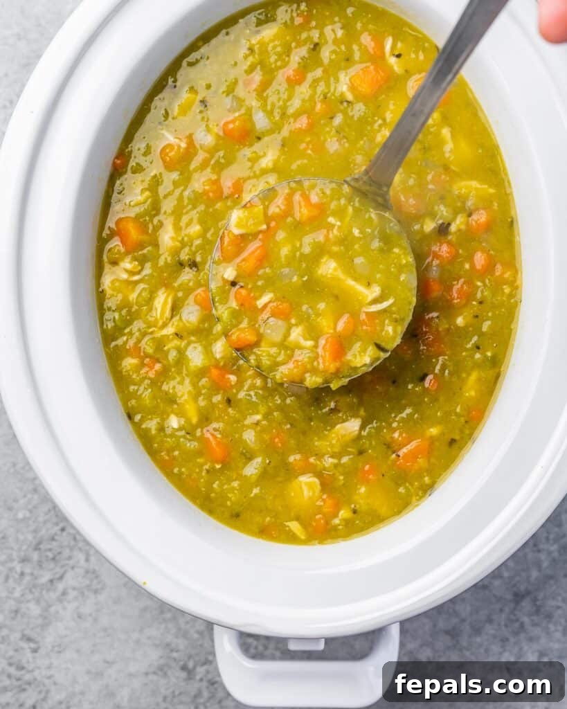 Ladling slow cooker split pea soup from a crockpot into a bowl.