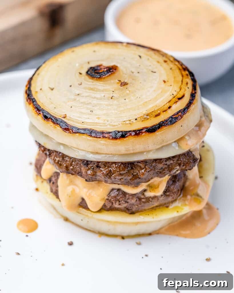 The Spectral Sailor Burger 2 side shot of flying dutchman with caramelized onion buns on a white plate
