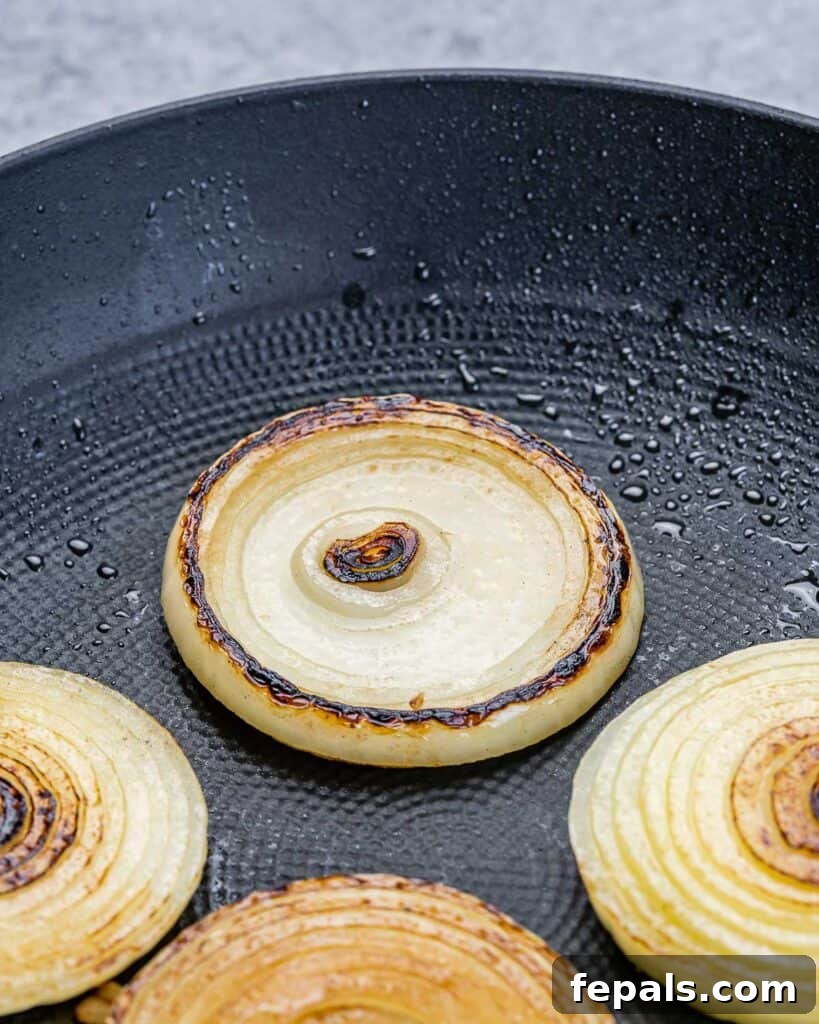 The Spectral Sailor Burger 5 sauteed onion slices on a pan