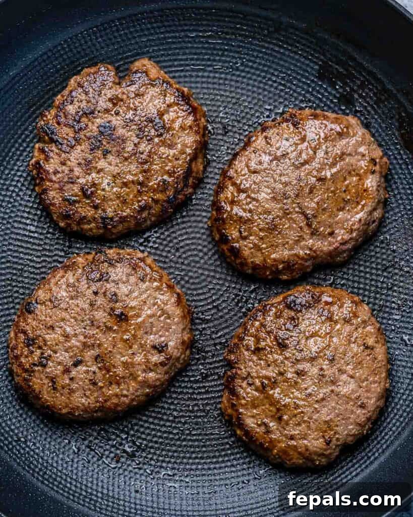 The Spectral Sailor Burger 6 4 burger patties cooked on a pan