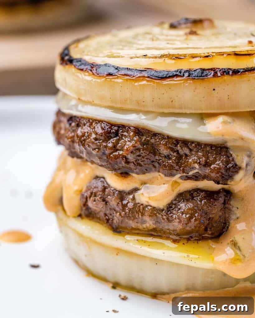 The Spectral Sailor Burger 9 close up side shot of flying dutchman burger on a plate with melted cheese