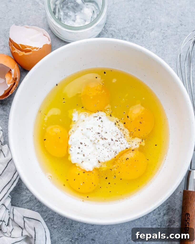 Creamy Protein Scramble 5 Eggs and cottage cheese in a white bowl.
