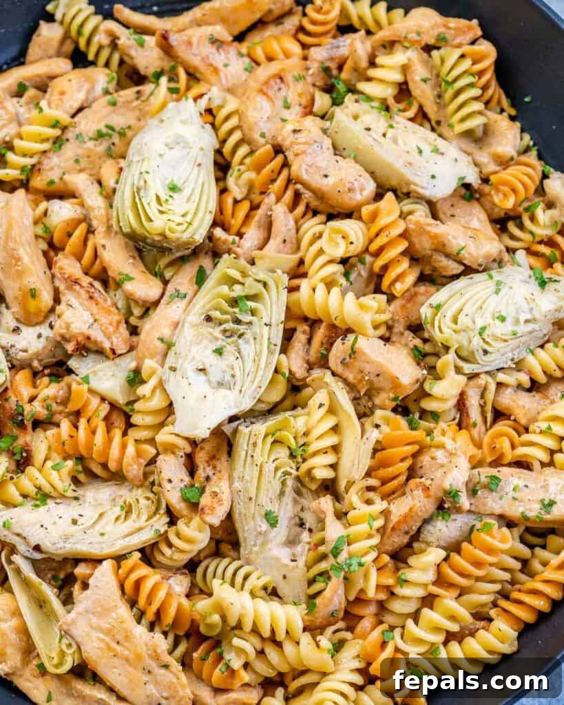 Creamy Chicken Artichoke Delight 3 top close up view of pasta dish with chicken and artichoke hearts