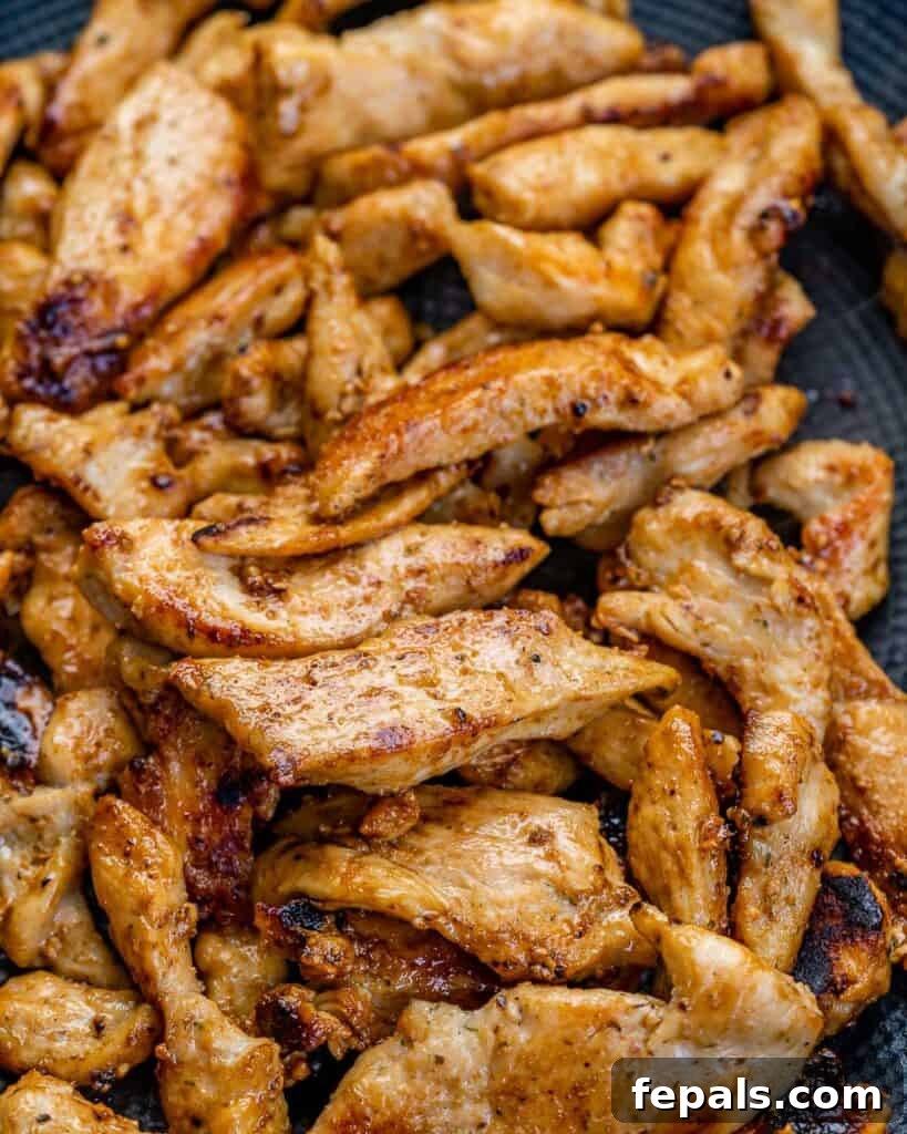 Creamy Chicken Artichoke Delight 5 seasoned and cooked sliced chicken in a skillet