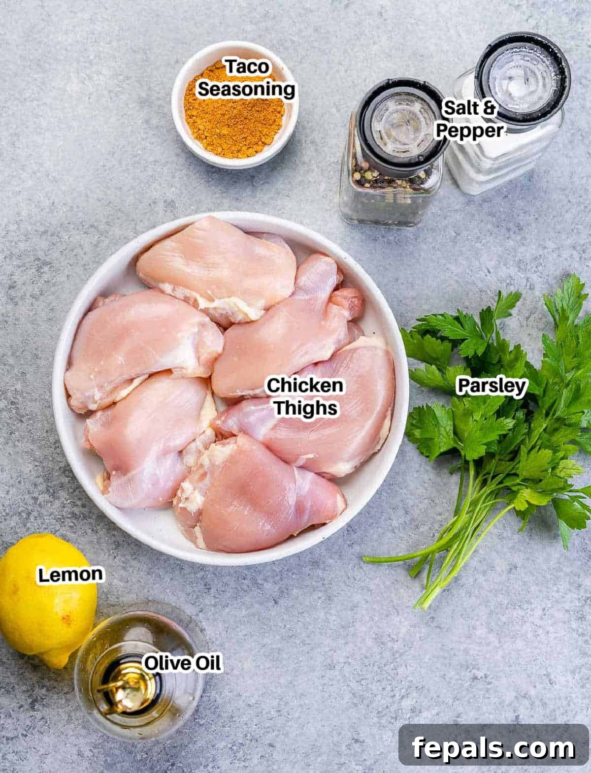 Crispy Air Fryer Boneless Chicken Thighs 4 Ingredients laid out on a table for making air fryer chicken thighs.