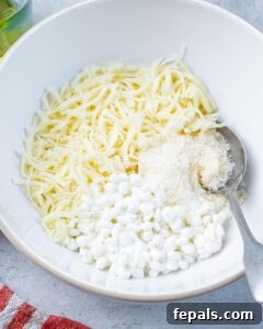 Mixing cottage cheese with mozzarella and parmesan cheese in a large bowl.