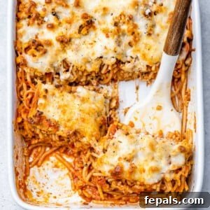 top view of casserole dish with baked spaghetti and melted cheese