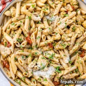 Top view of creamy penne pasta with chicken and sun-dried tomatoes, the star of the Marry Me Chicken Pasta recipe.