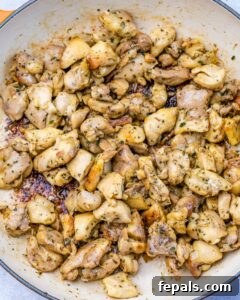 Cooked chicken thighs bites in a pan