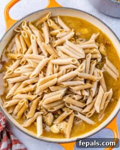 cooked pasta added over the creamy chicken sauce