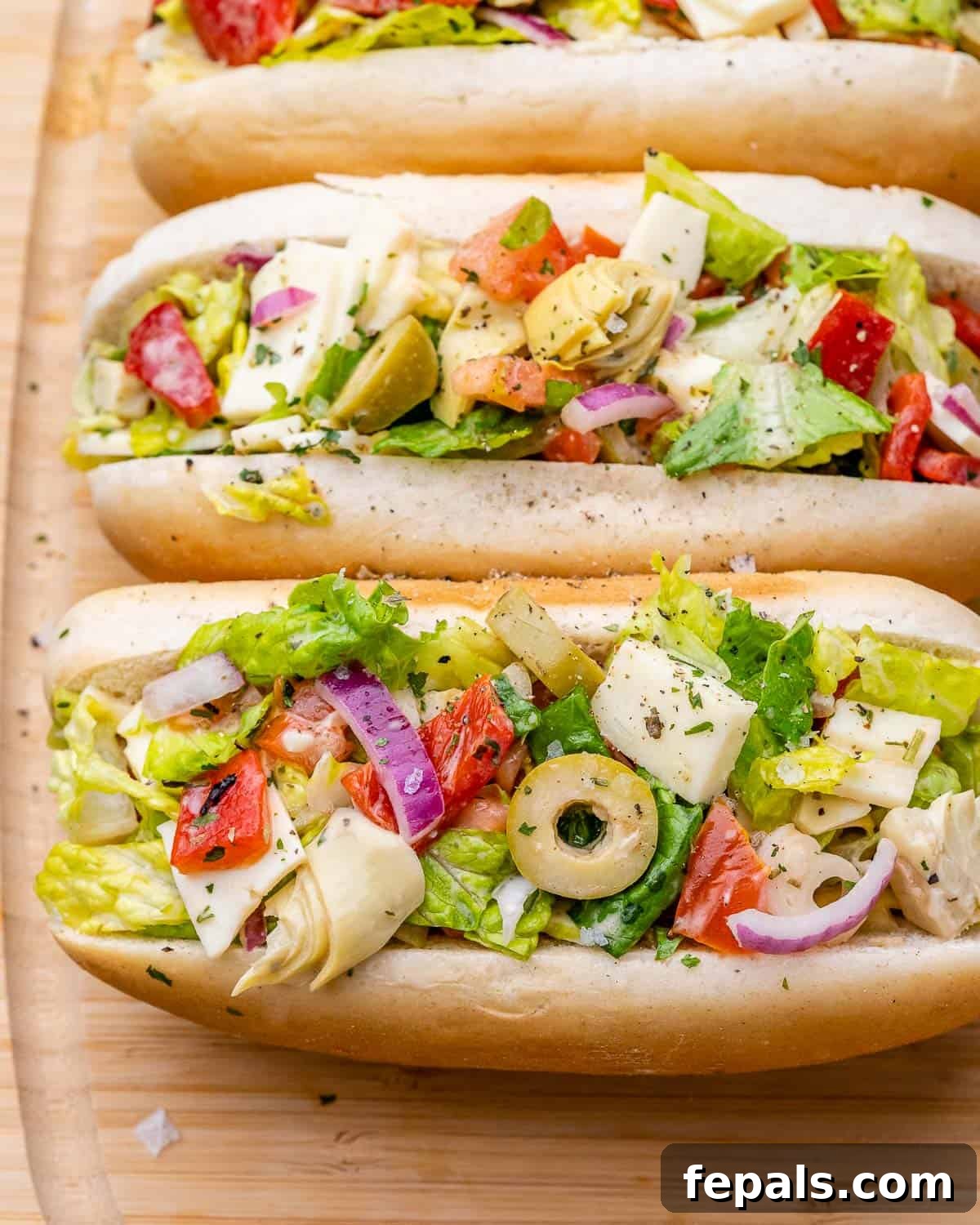 Ultimate Chopped Italian 2 Overhead shot of buns filled with chopped Italian salad.