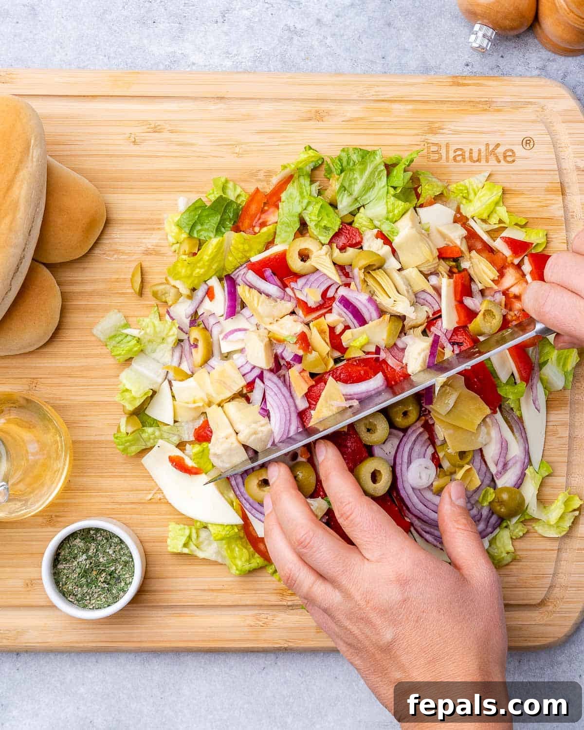 Ultimate Chopped Italian 7 Chopping veggies on a cutting board.
