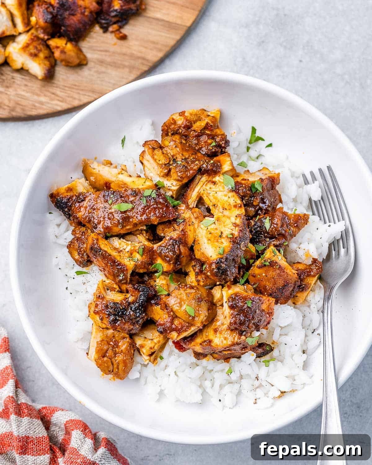 Smoky Chipotle Al Pastor Chicken 6 A beautifully presented bowl of white rice generously topped with succulent, chopped homemade Chipotle Chicken Al Pastor, ready to be enjoyed.