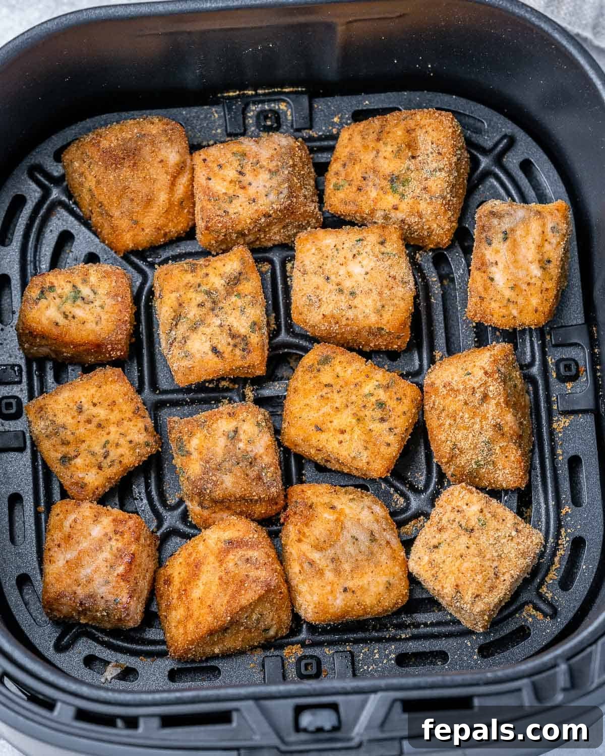 Salmon cooking in an air fryer.