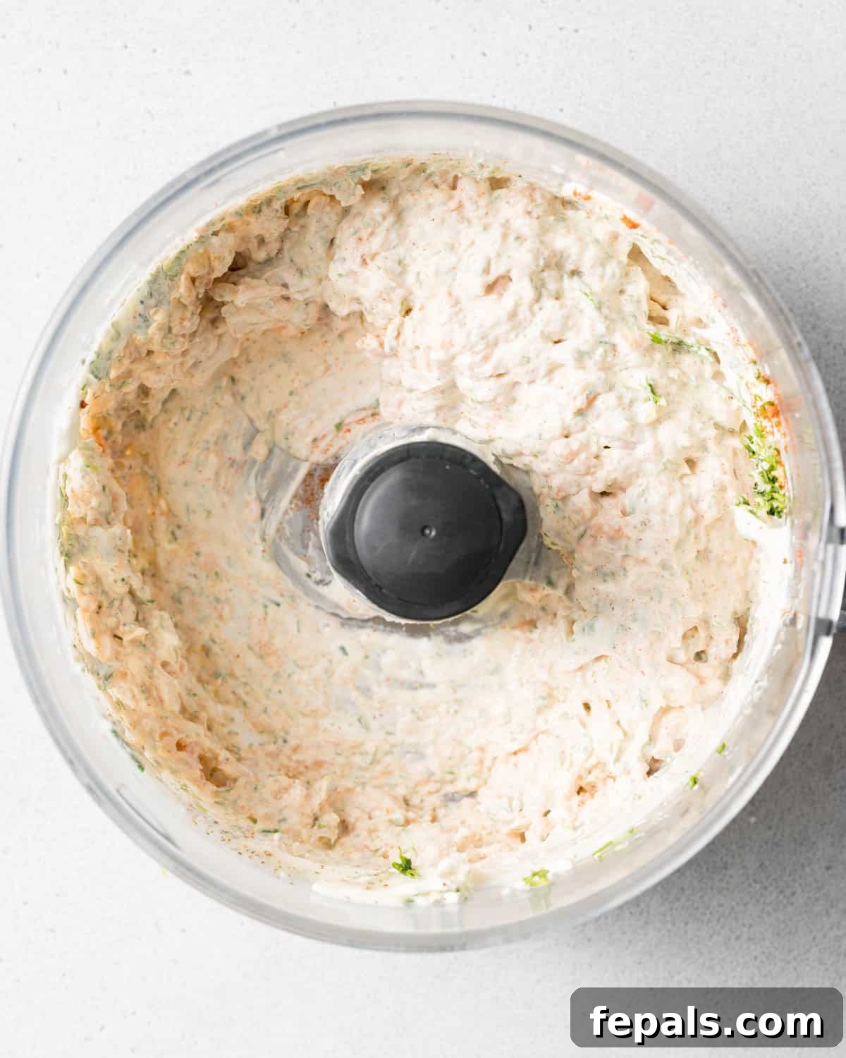 Smoked salmon dip mixed in a food processor.