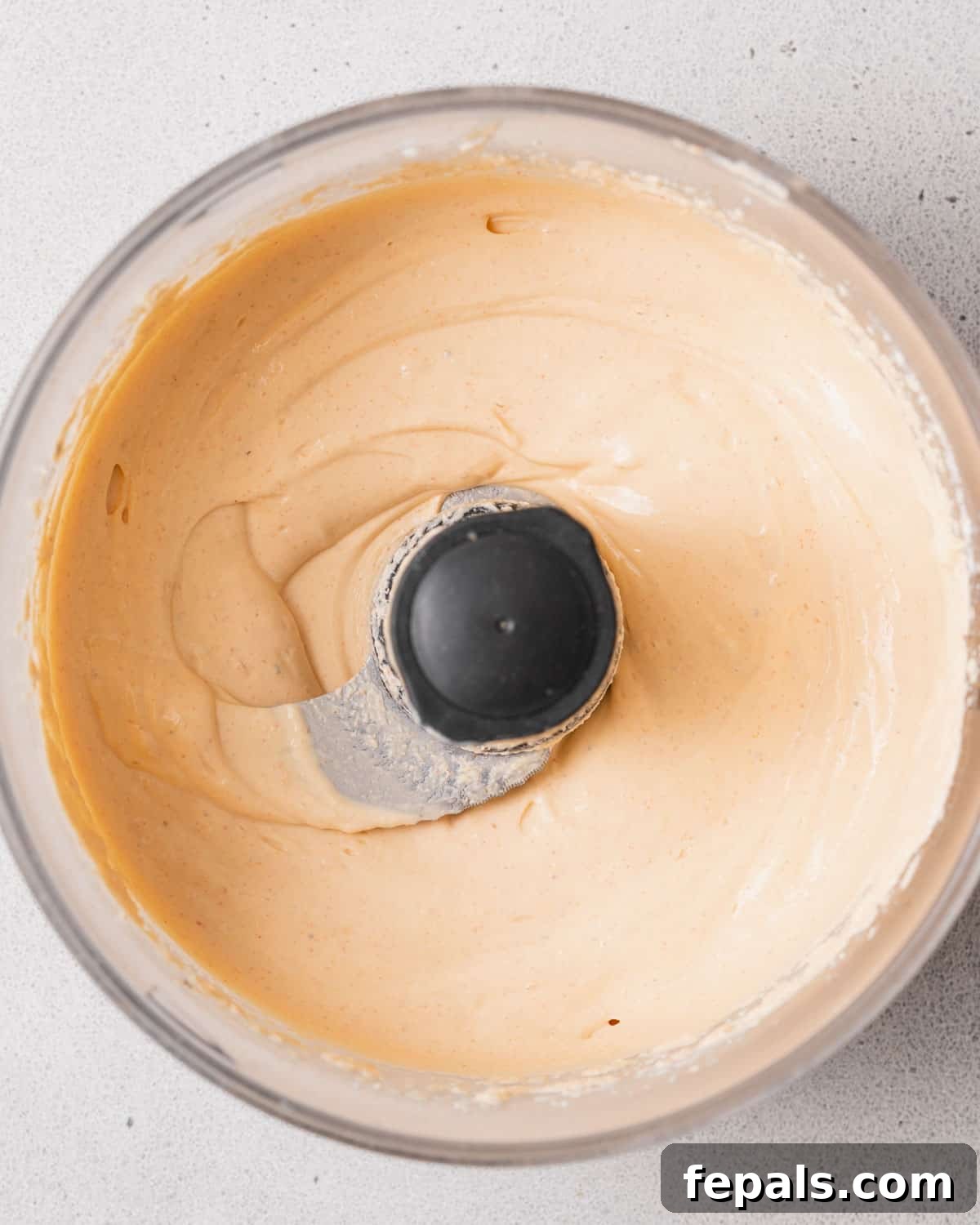 The Creamy Cottage Cheese Queso Hack 6 Smooth, blended cottage cheese and taco seasoning in a food processor, transformed into a creamy base.