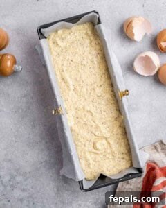 Cottage cheese bread batter poured into the prepared loaf pan, ready for baking.