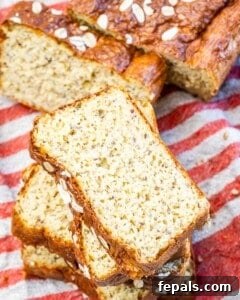 Slices of fresh baked cottage cheese bread resting on a red and white towel, showcasing its inviting texture.