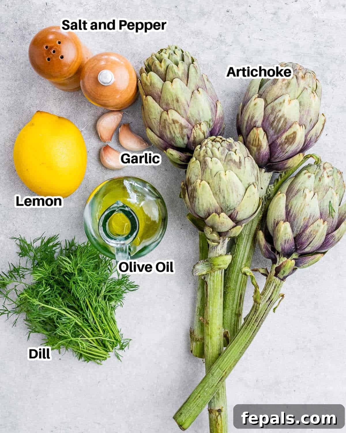 Smoky Grilled Artichoke Halves 3 A vibrant selection of ingredients for grilled artichokes, including fresh globe artichokes, bright lemons, fragrant garlic cloves, and a bottle of golden olive oil.