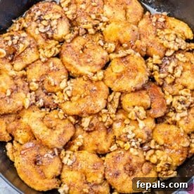 a black skillet with cooked honey walnut shrimp.