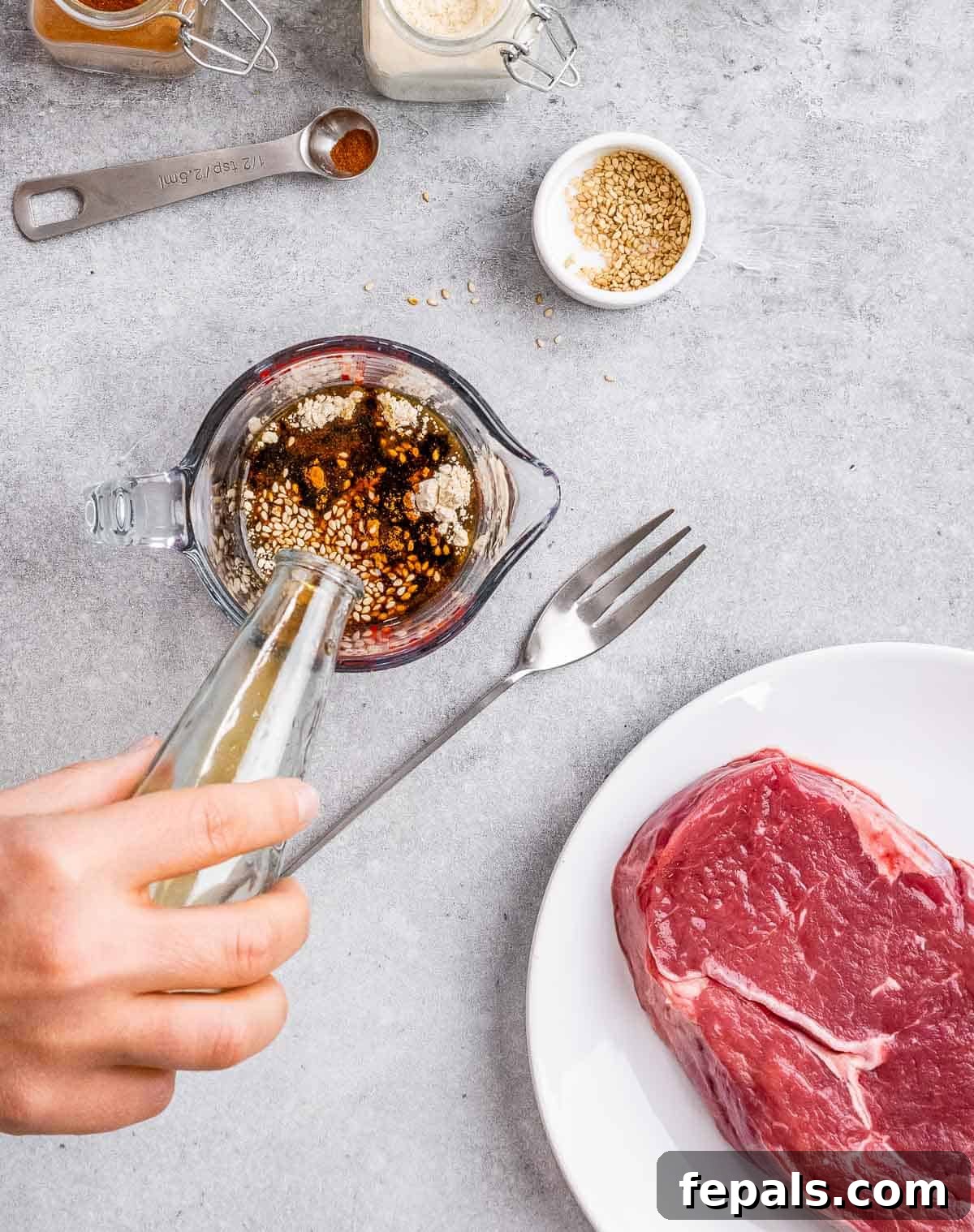 Sweet and Savory Teriyaki Steak 5 Mixing together marinade in a glass measuring cup.