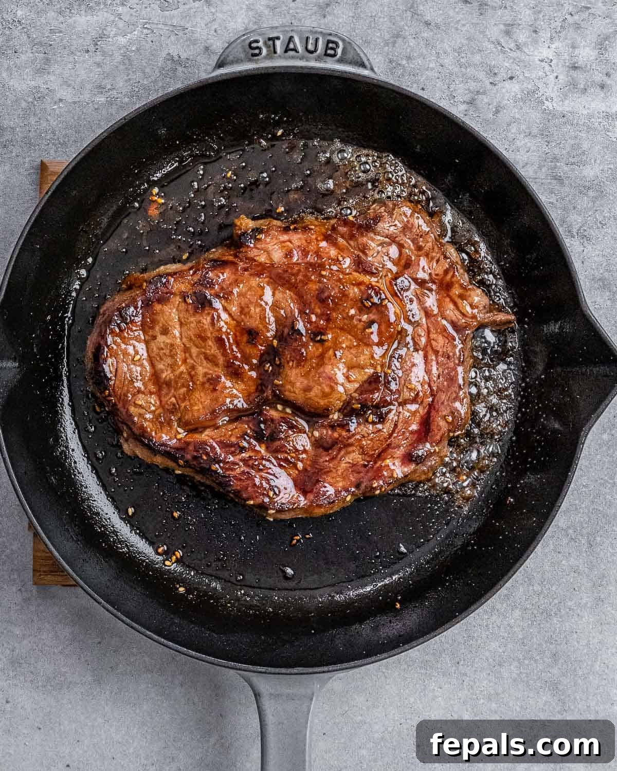 Sweet and Savory Teriyaki Steak 8 Cooking steak in a large skillet.