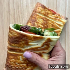 The Viral Cottage Cheese Wrap 12 hand holding half a sandwich wrap.
